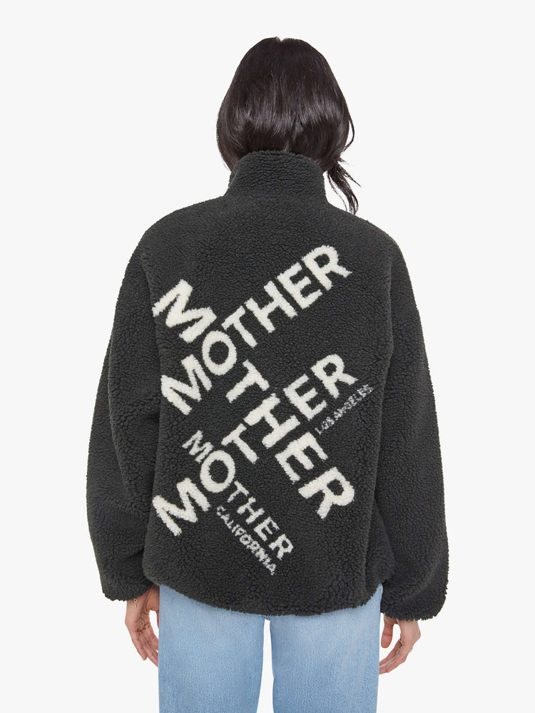 Back view of a woman in a reversible fleece jacket with a stacked collar, zip closure, patch pocket at the chest, slightly dropped shoulders and a loose fit.