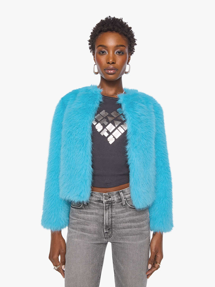 Font view of a woman in a bight light blue cropped jacket with a crewneck and boxy fit.