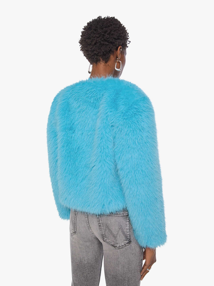 Back view of a woman in a bight light blue cropped jacket with a crewneck and boxy fit.