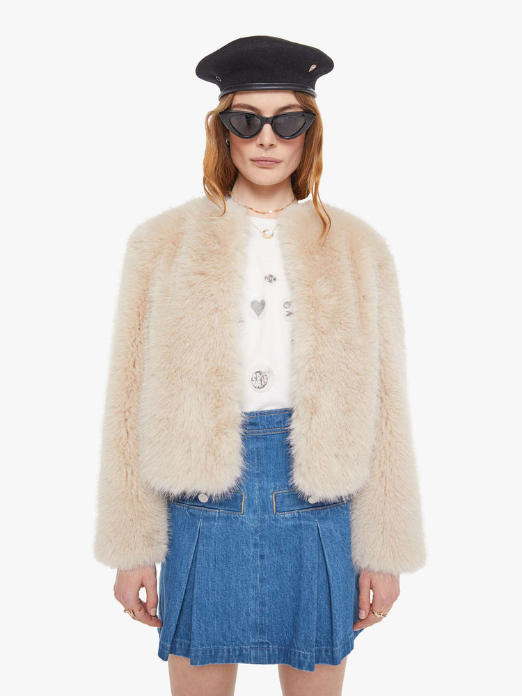 Front view of a light pink faux fur  cropped jacket with a crewneck and boxy fit. 