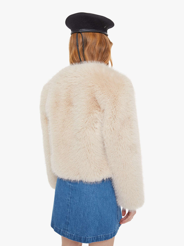 Back view of a light pink faux fur  cropped jacket with a crewneck and boxy fit. 