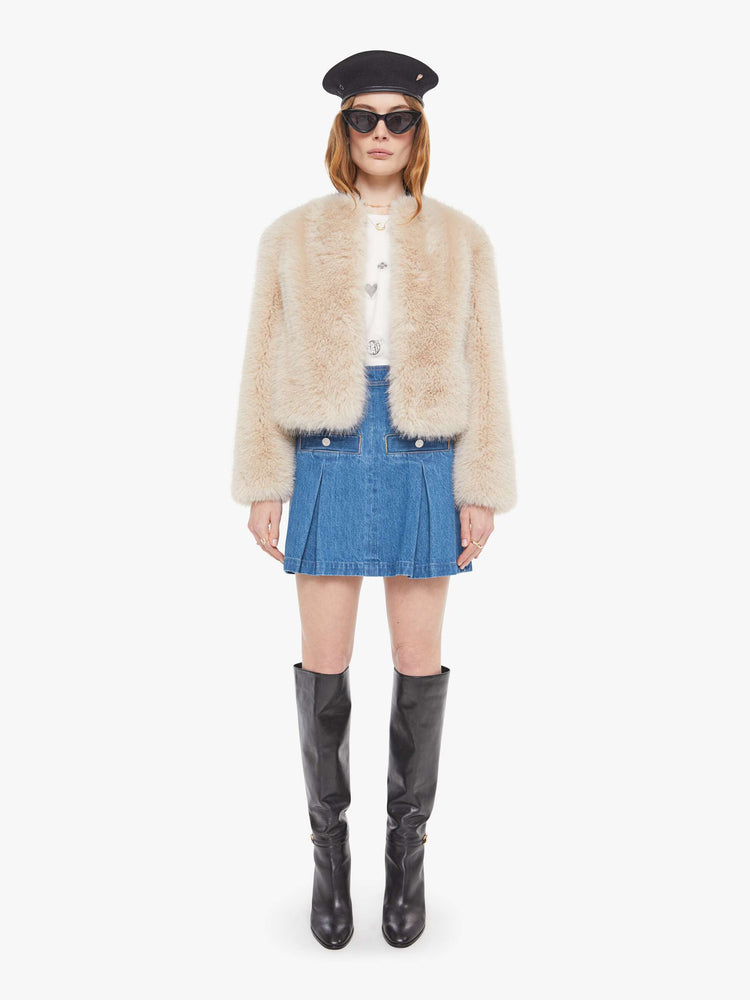 Full body view of a light pink faux fur  cropped jacket with a crewneck and boxy fit. 