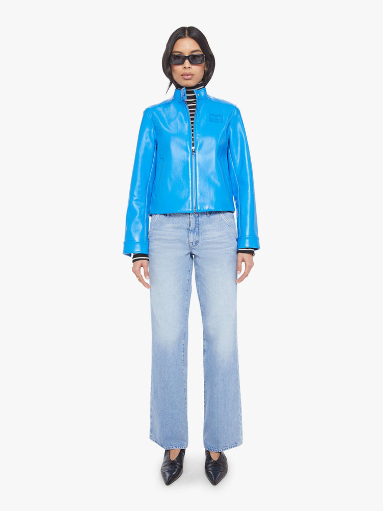 Full body view of a baby blue moto-inspired zip-up jacket with a short stacked collar, slit pockets and a slightly narrow fit.