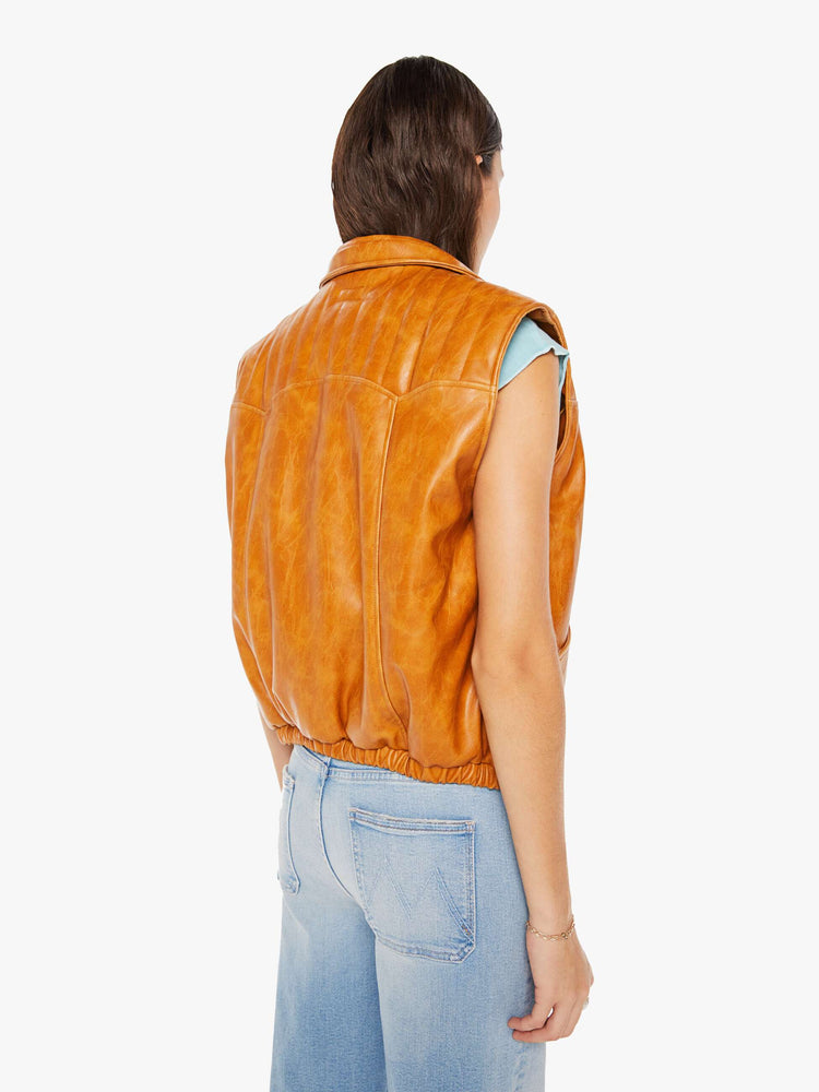 Back view of a womens brown faux leather vest featuring a collar and snap buttons.