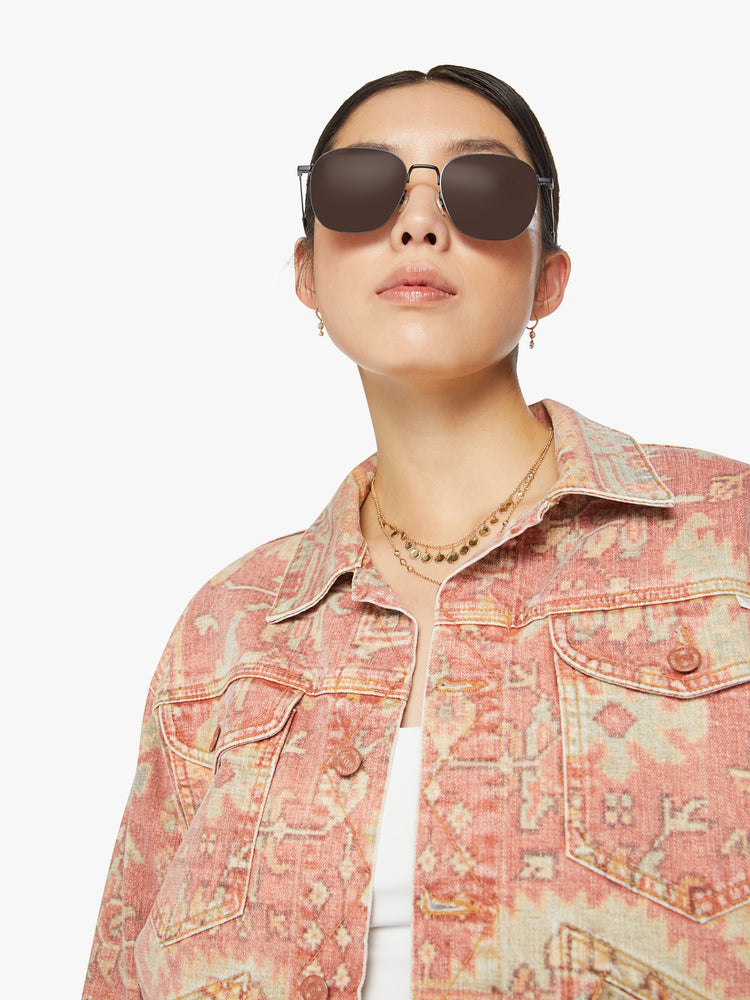 Close up view of a woman button-up jacket with drop shoulders, front patch pockets and a cropped, boxy fit in a Moroccan rug print.