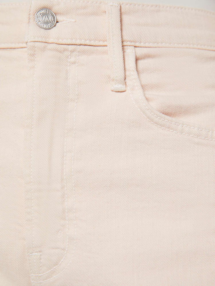 Swatch view of a woman in pure peach super high-waisted bermuda shorts with a zip fly, wide leg, knee-length inseam and a frayed hem.