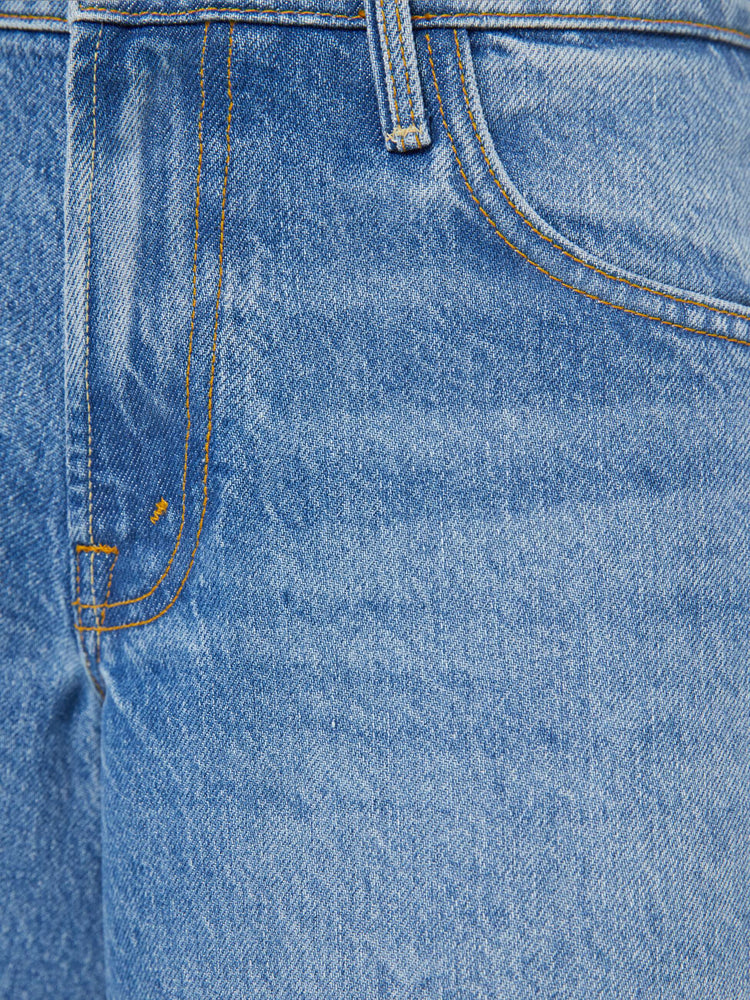 Swatch view of a woman in a mid blue mid-waisted shorts have a low-slung fit, zip fly, loose wide-leg and a 15-inch inseam with a clean hem.