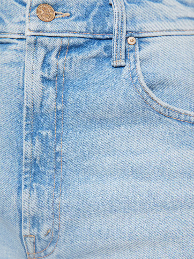 Swatch view of a woman in a light blue high-waisted shorts have a low-slung fit and feature a wide leg, zip fly, calf-length inseam and a frayed hem.