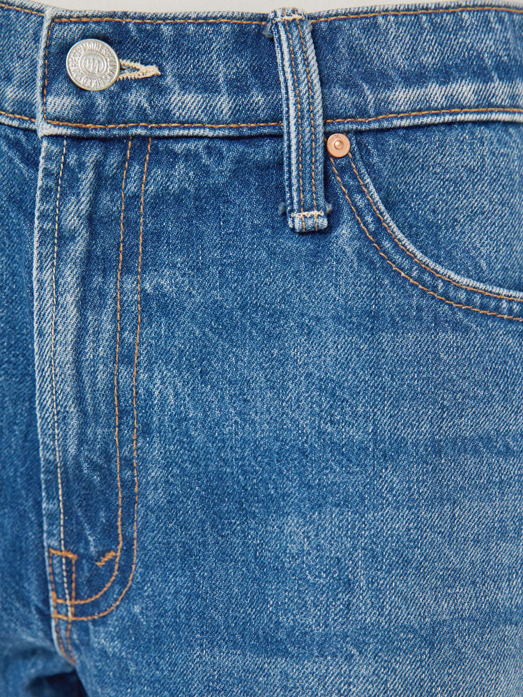 Swatch view of a woman in a classic blue shorts designed to sit lower on the hips with a loose leg, zip fly and 2.5-inch inseam with a frayed hem.