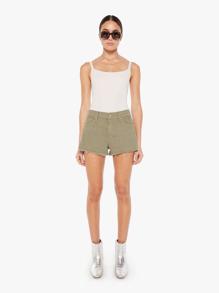 Front view of a greenish brown denim short featuring a relaxed mid rise and a short frayed hem.