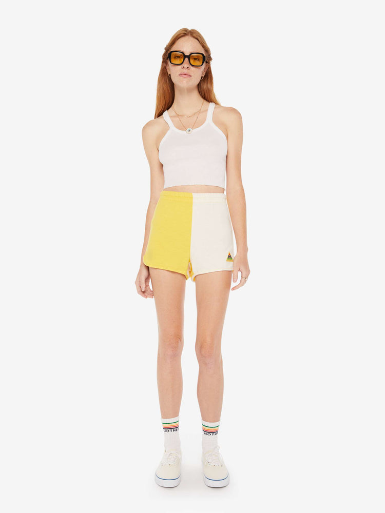 Front view of a womens yellow and white short featuring a high rise and elastic waist.