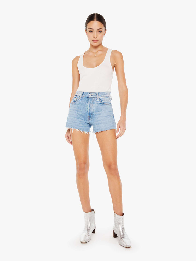 Front view of a womens light blue wash denim short featuring a high rise and a short frayed hem.
