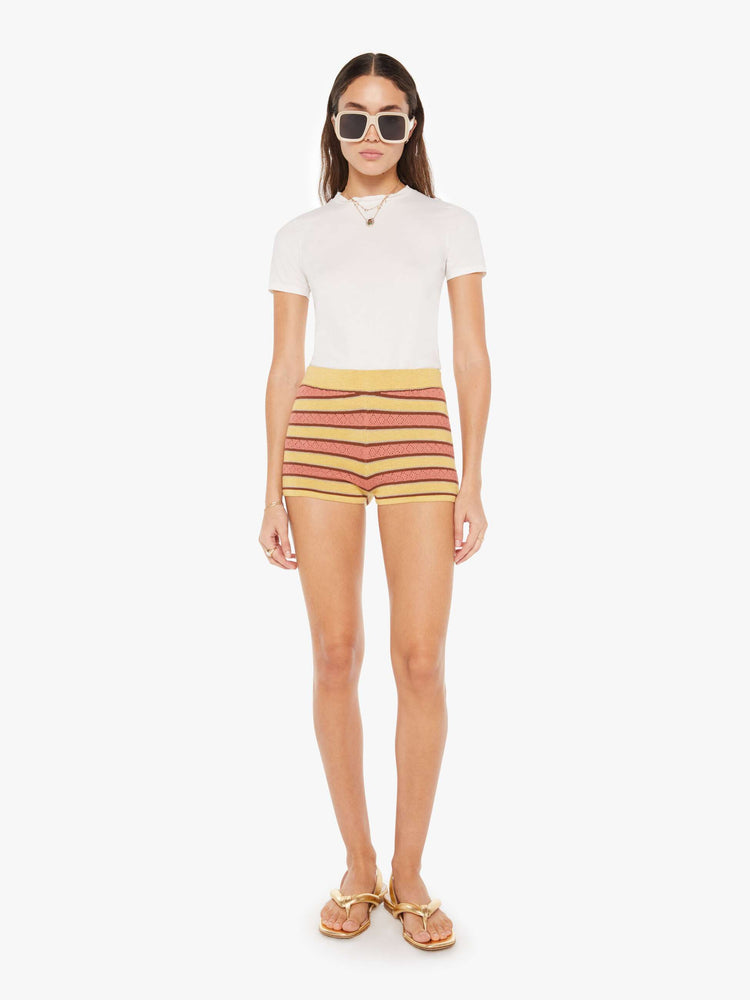 Front view of a womens knit short featuring an elastic waistband and earth toned stripes.