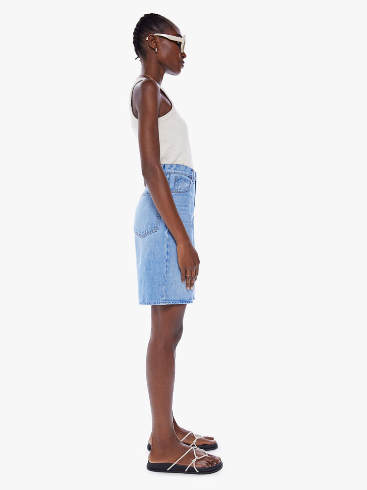 Side view of Wide-leg denim shorts from SNACKS! with a high rise, 8-inch inseam, clean hem in a faded mid-blue wash.