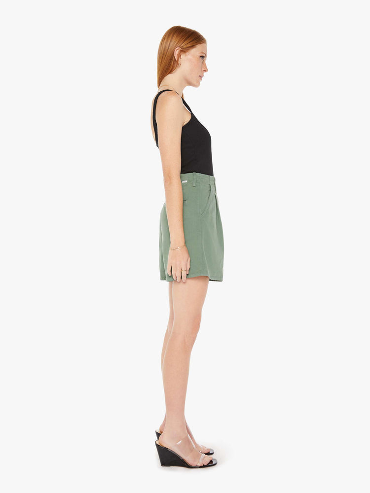 Side view of an army green short featuring a super high rise with front pleats and a wide leg opening.