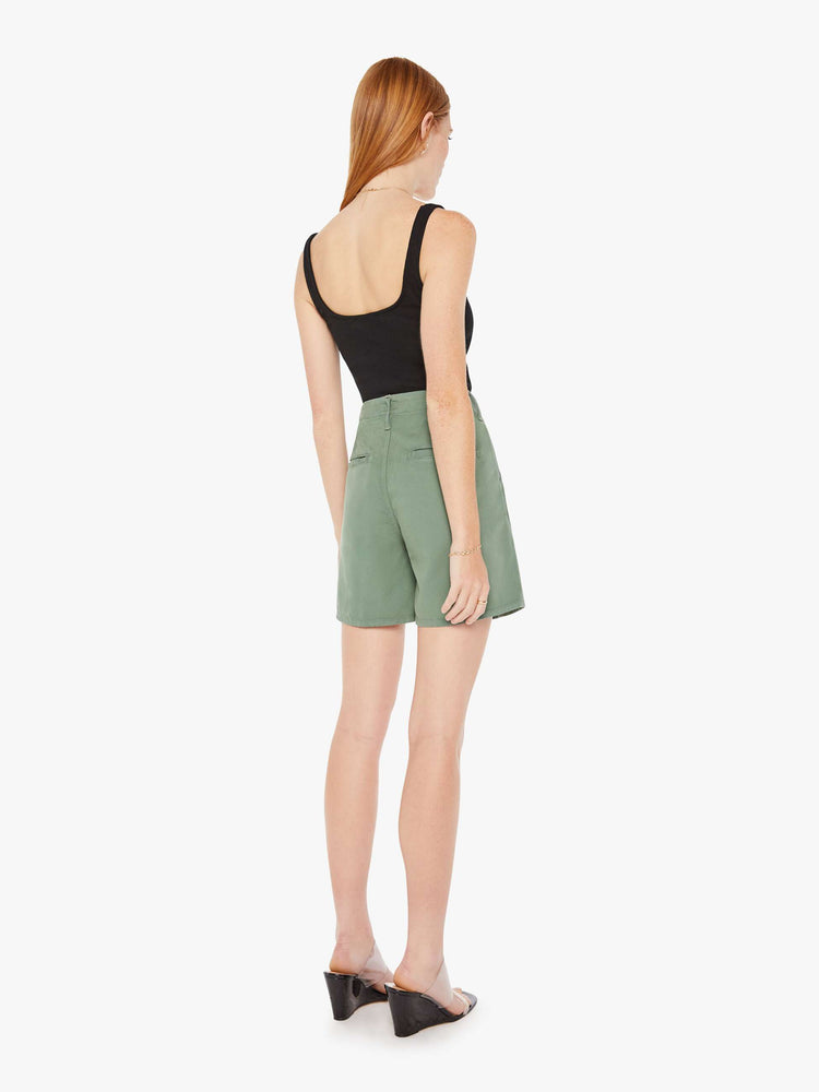 Back view of an army green short featuring a super high rise with front pleats and a wide leg opening.