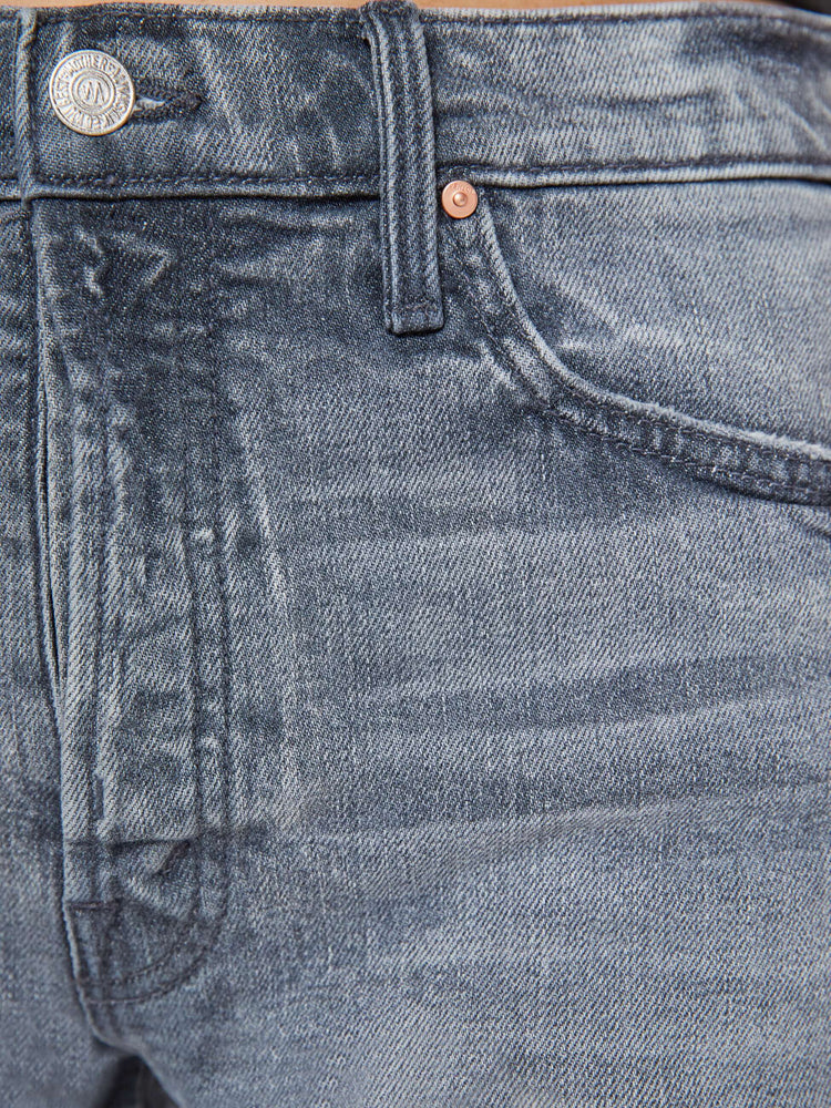 Swatch view of a woman in a light grey high-waisted denim shorts with a button fly, frayed hem and vintage-inspired fit.