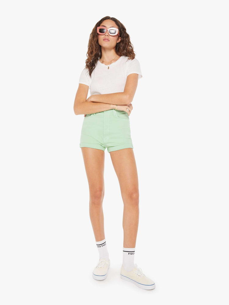Front view of a woman in vintage-inspired shorts designed with a super-high rise, narrow fit and a short cuffed hem.