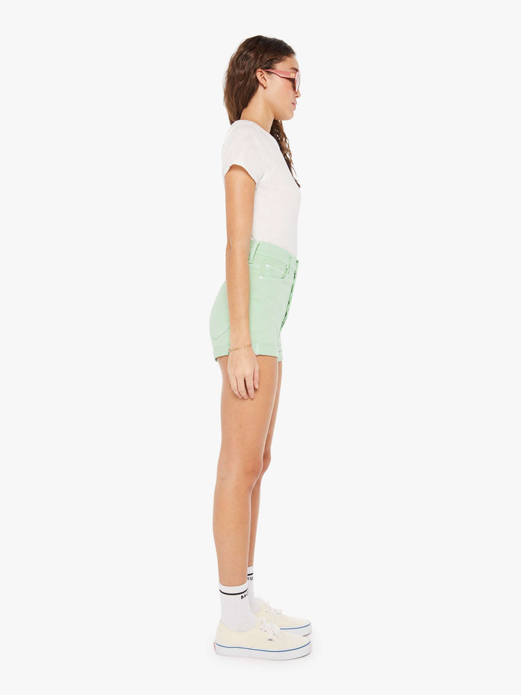 Side view of a woman in vintage-inspired shorts designed with a super-high rise, narrow fit and a short cuffed hem.