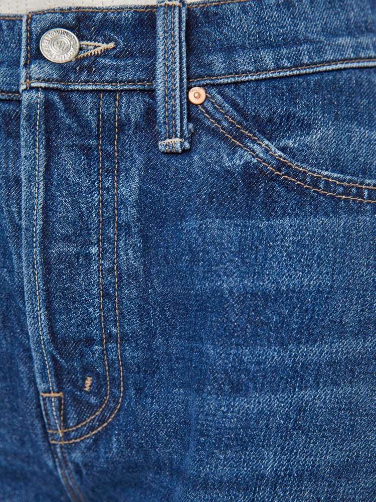Swatch view of a woman in a super high-waisted denim shorts with a button fly, 3.25-inch inseam and a wide leg opening that flares out.