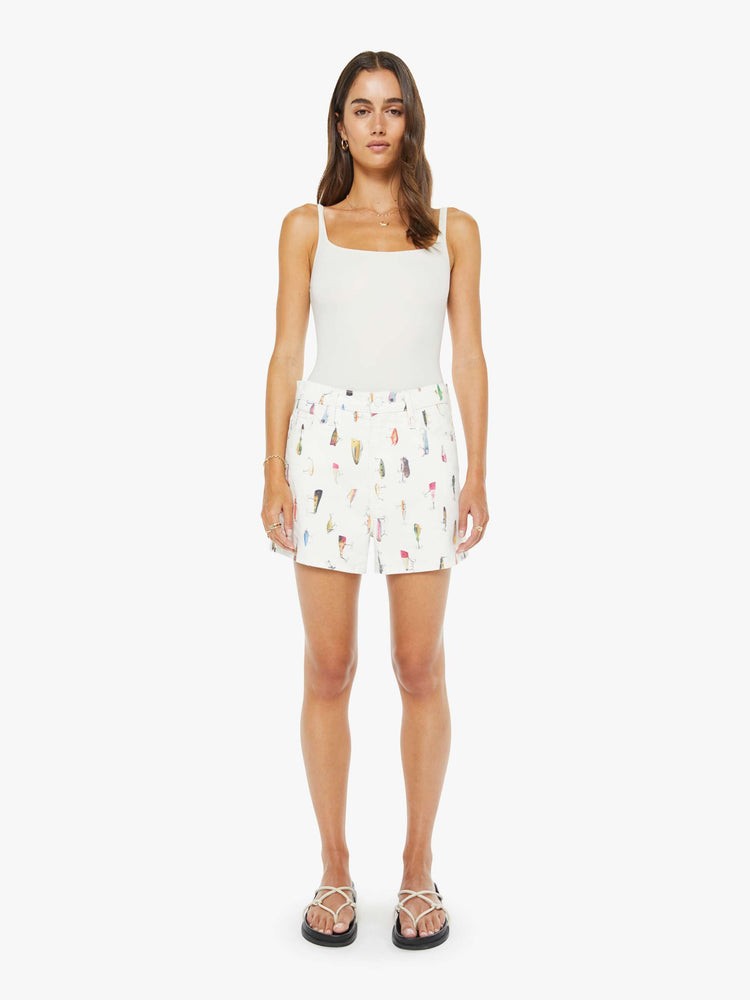 Front view of a woman in an off-white with a faded fishing lure print super high waisted shorts with a 3.5-inch inseam, zip fly, clean hem and a loose fit.
