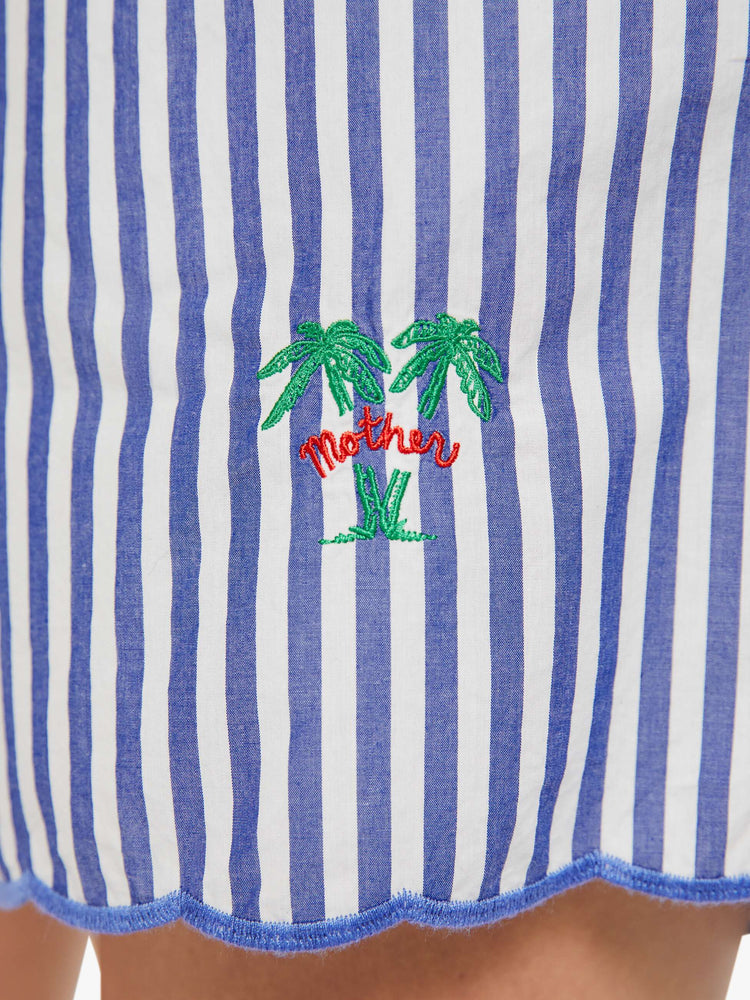 Swatch view of a woman in shorts with blue and white stripes with MOTHER's name embroidered with two small palm trees at the hem.
