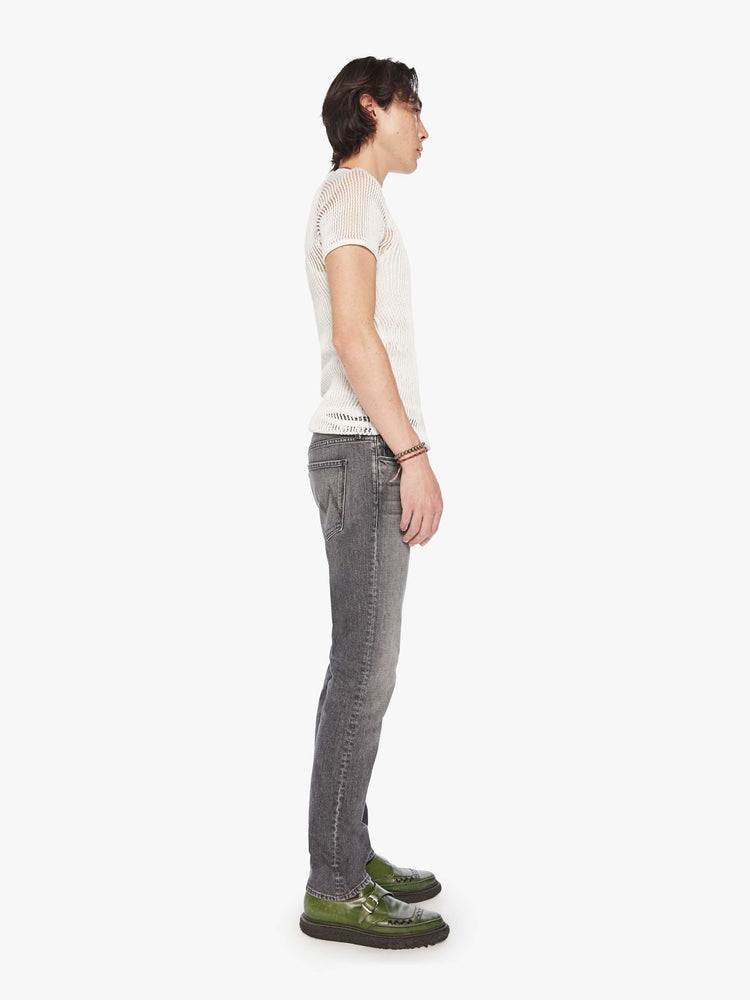 Side view of a men dark grey slim-straight leg with a mid rise, 32-inch inseam and a clean hem denim.