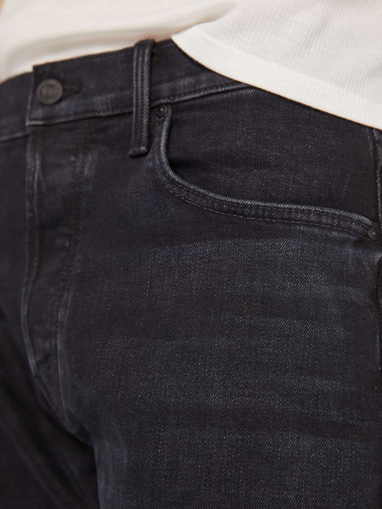 Swatch view of a men mid-rise straight leg with a 32-inch inseam and a clean hem in a black wash.