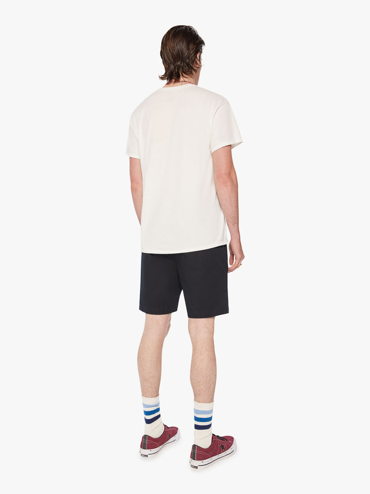 Back view of men jean short with a straight leg, slash pockets and an inseam above the knee in a dark navy hue.