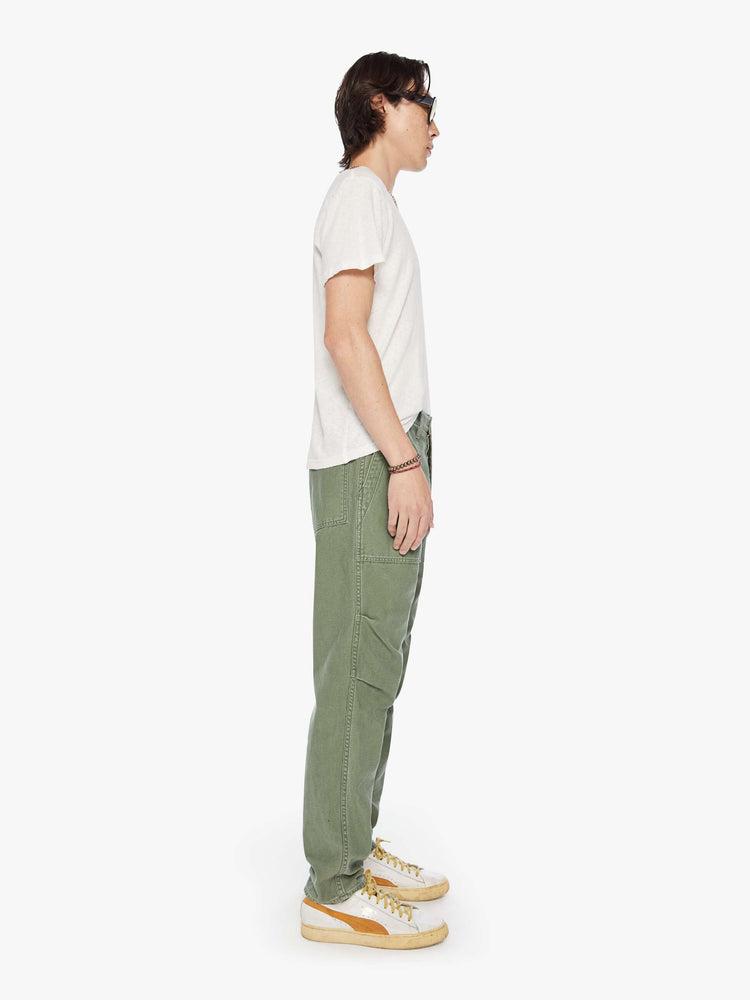 Side view of a mens army pant with a slightly dropped crotch, patch pockets and a slim-straight leg.