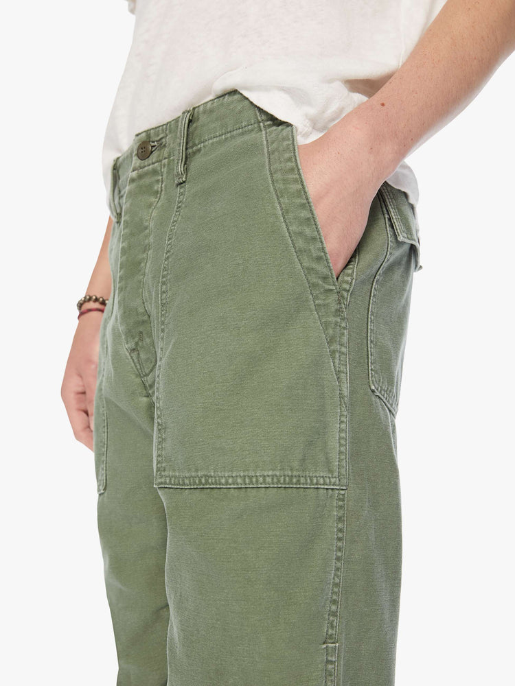 Close up view of a mens army pant with a slightly dropped crotch, patch pockets and a slim-straight leg.