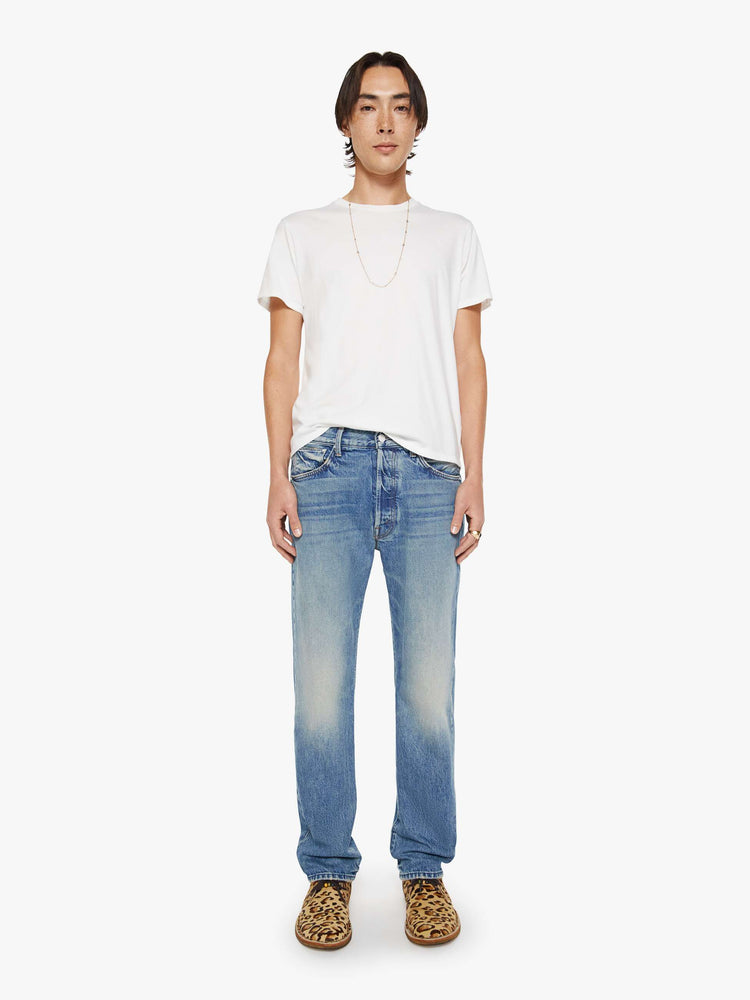 Front view of a woman in a light blue classic straight leg with a mid rise, button fly, 32-inch inseam and a clean hem.