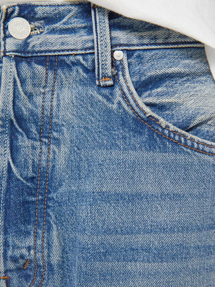 Swatch view of a woman in a light blue classic straight leg with a mid rise, button fly, 32-inch inseam and a clean hem.