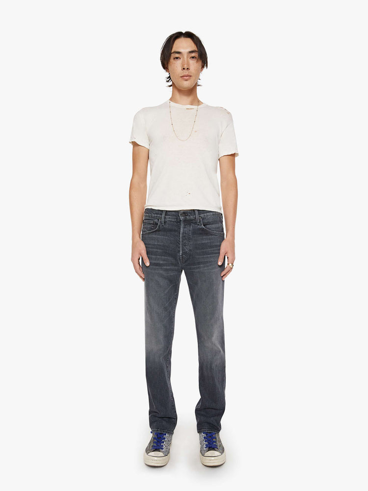 Front view of a man in faded black classic straight leg with a mid rise, button fly, 32-inch inseam and a clean hem.