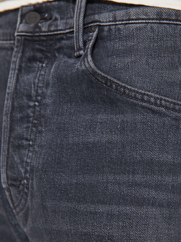 Swatch view of a man in faded black classic straight leg with a mid rise, button fly, 32-inch inseam and a clean hem.