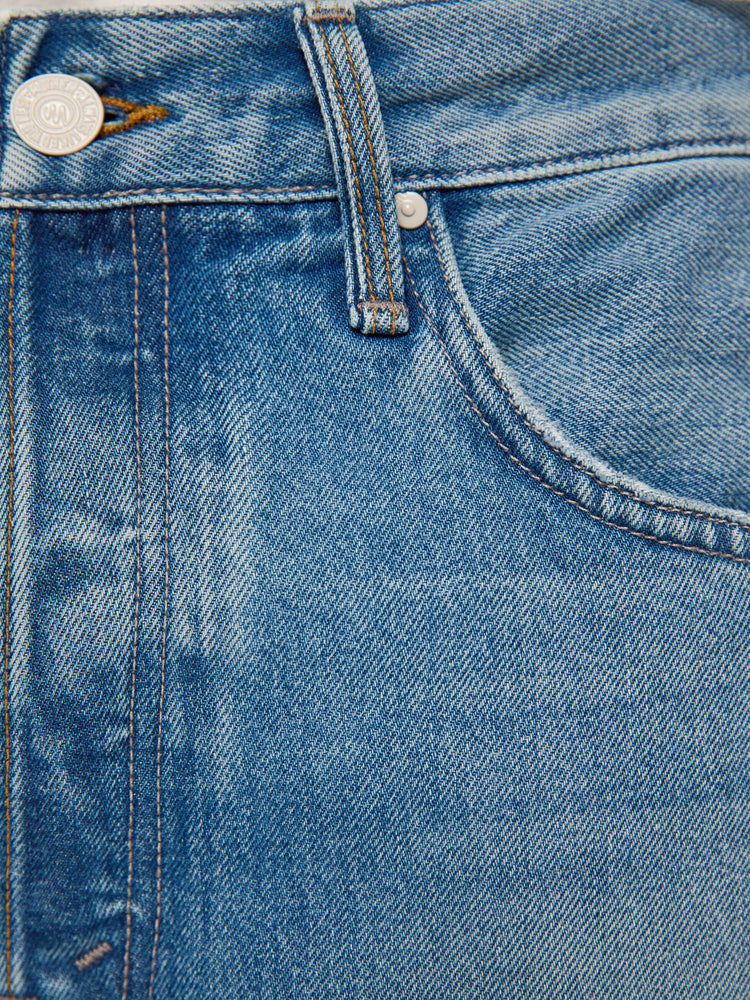 Swatch view of a man in light blue classic straight leg with a mid rise, button fly, 32-inch inseam and a clean hem.