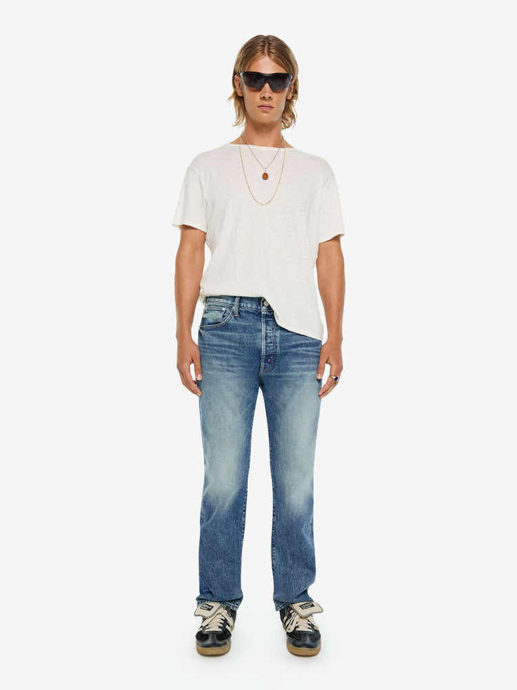 Front view of a man in a classic straight leg with a mid rise, button fly, 32-inch inseam and a clean hem.