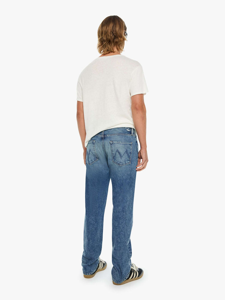 Back view of a man in a classic straight leg with a mid rise, button fly, 32-inch inseam and a clean hem.