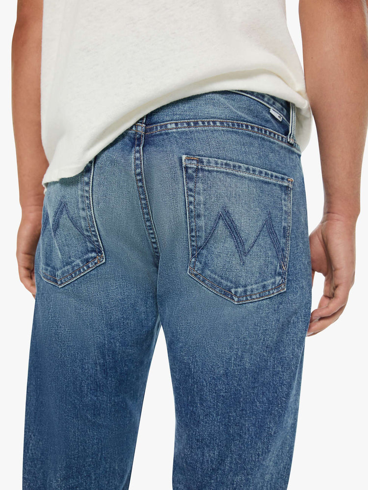 Back close up view of a man in a classic straight leg with a mid rise, button fly, 32-inch inseam and a clean hem.