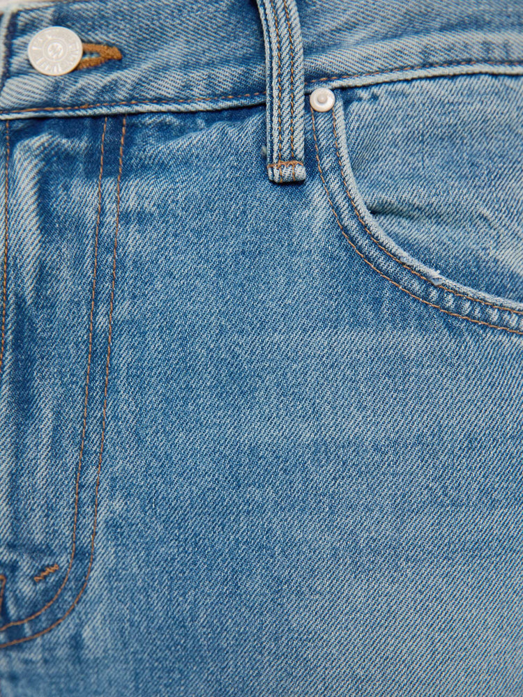 Swatch view of a man in a light blue straight-leg jean with a mid rise, zip fly, 30-inch inseam and a clean hem.