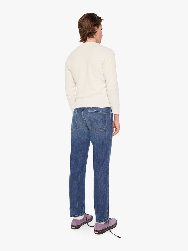 Back view of a mens straight-leg jean with a mid rise, ankle-length inseam and a clean hem in a dark blue wash.