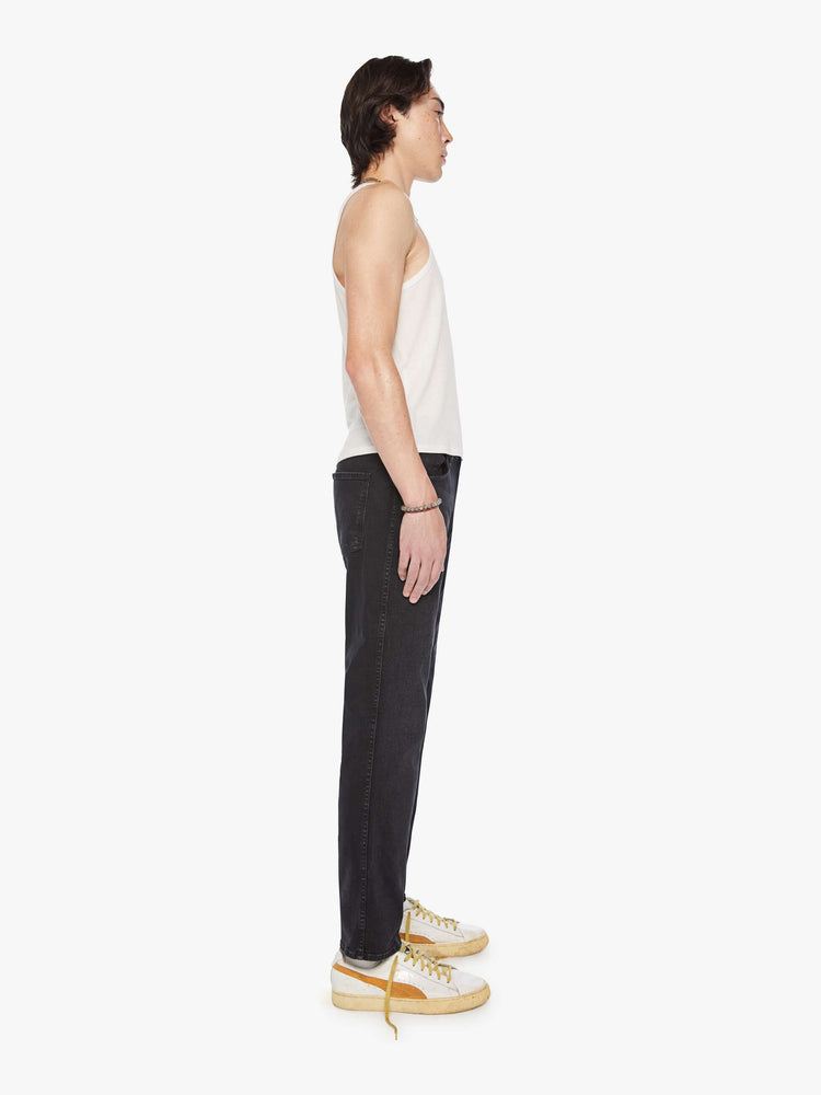 Side view mens straight-leg jean with a mid rise, ankle-length inseam and a clean hem in a black wash.