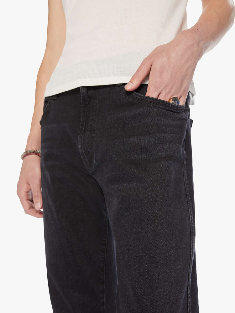 Waist close up view mens straight-leg jean with a mid rise, ankle-length inseam and a clean hem in a black wash.
