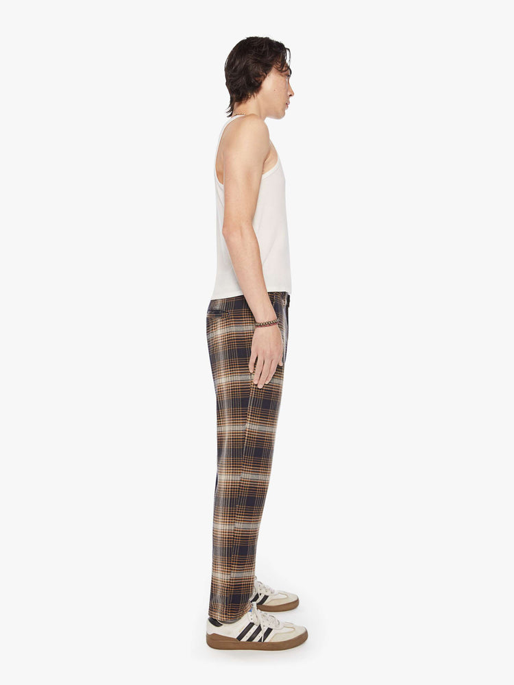 Side view of a mens classic pant with slash pockets and a relaxed, slim-straight leg in a vintage-inspired navy, white and orange plaid print.