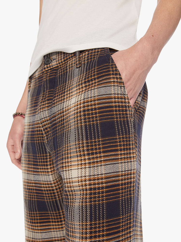 Waist close up view of a mens classic pant with slash pockets and a relaxed, slim-straight leg in a vintage-inspired navy, white and orange plaid print.