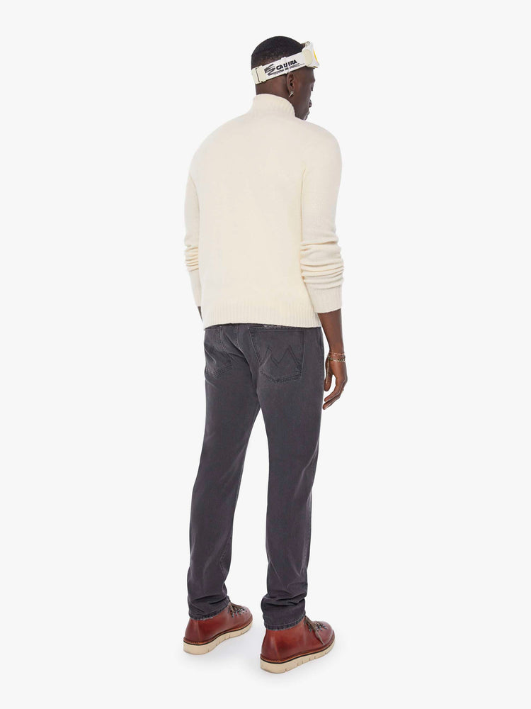 Back view of a man in a dark grey  standard straight leg with a mid rise, button fly and 32-inch inseam with a clean hem. 