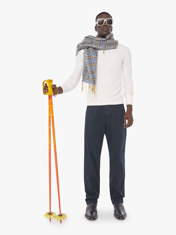 Front view of a man in  a blue jean with a mid rise, zip fly and loose leg.