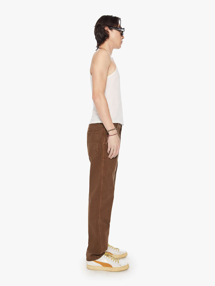 Side view of a men classic pant with utilitarian pockets, a hammer loop and relaxed leg in a dark brown wash.