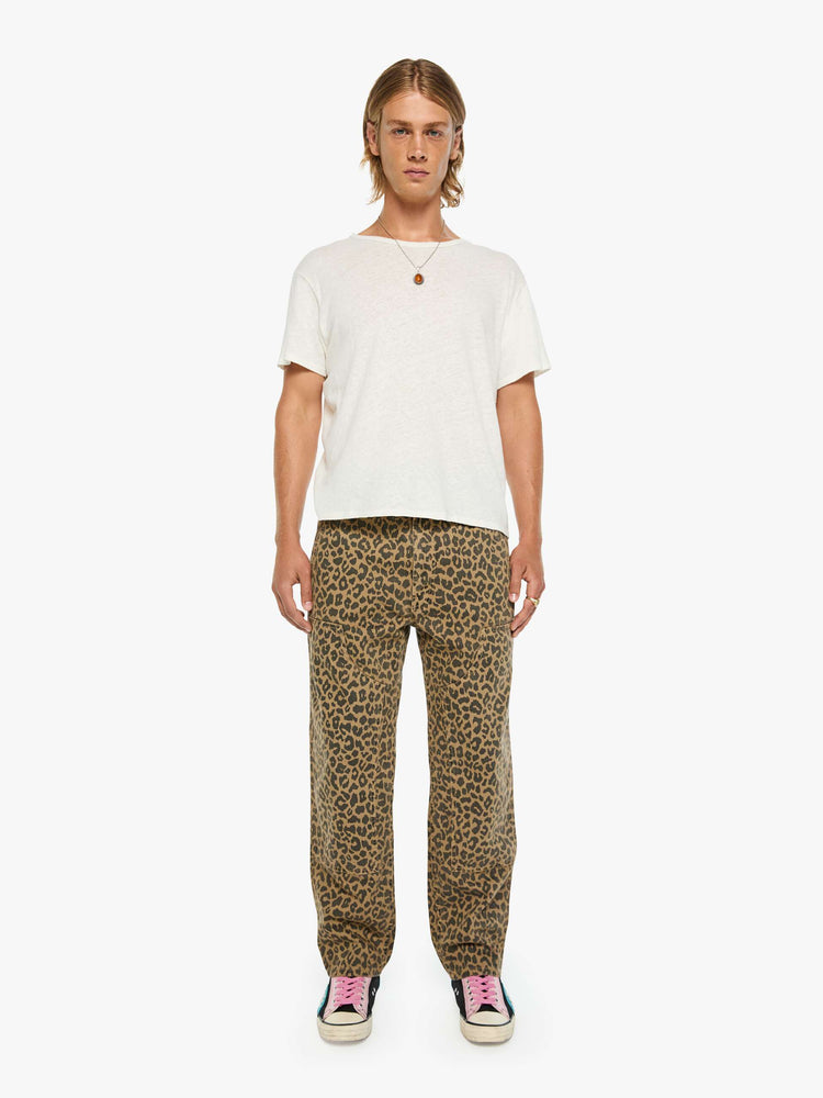Front view of a man in a leopard print classic pant with patch pockets, a zip fly, hammer loop and loose leg.