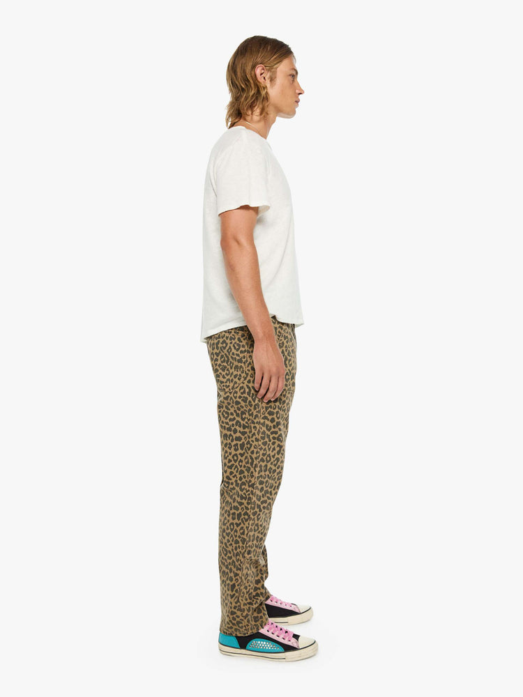 Side view of a man in a leopard print classic pant with patch pockets, a zip fly, hammer loop and loose leg.